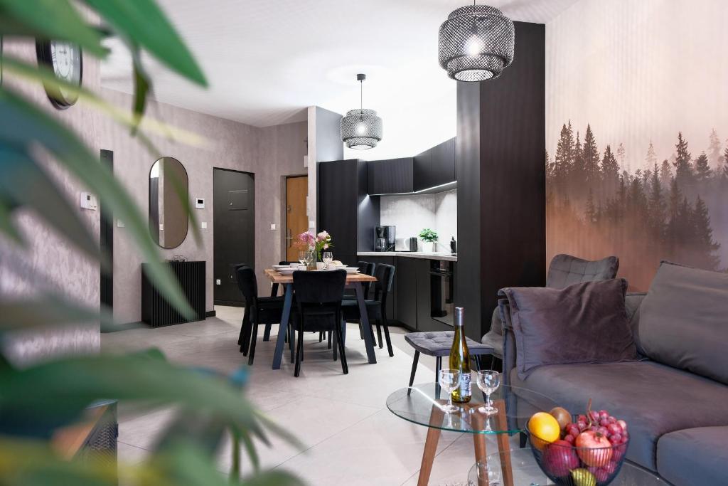 a living room with a couch and a table at Laguna Beskidów Resort - Apartament A28 Premium in Zarzecze