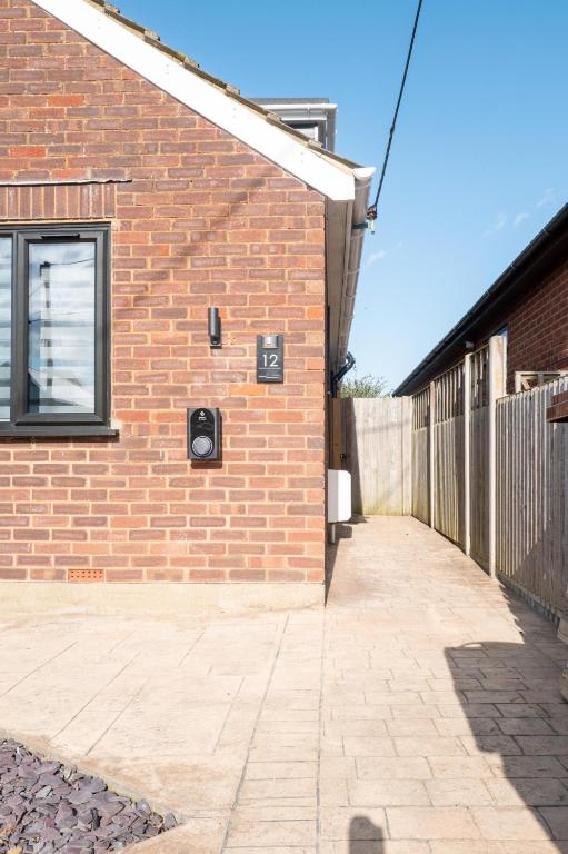 a brick building with a window on the side of it at Family & Pet-Friendly Seaside Bungalow with Accessible Features in Minster