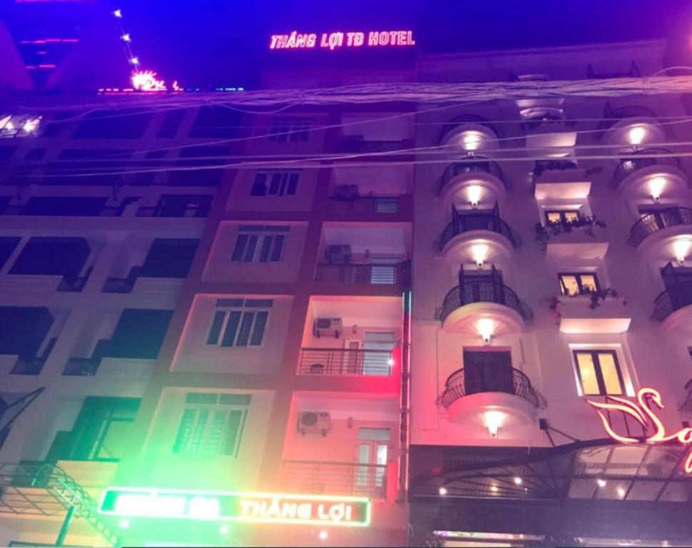 a building with colorful lights on the side of it at Thang Loi Tam Dao Hotel in Tam Ðảo