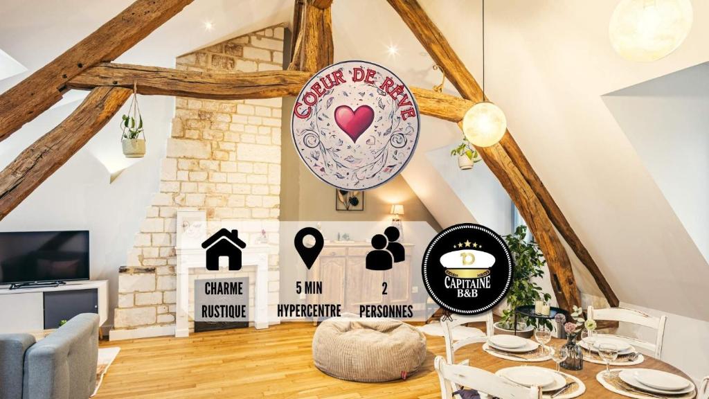 a living room with a table and a sign at Coeur de Rêve - 5min hypercentre in Troyes