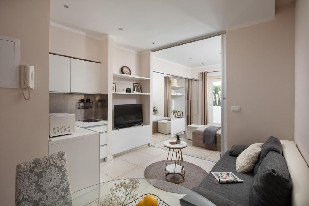 a living room with a couch and a kitchen at Luxury 4 star apartment in the Old Town Zadar in Zadar