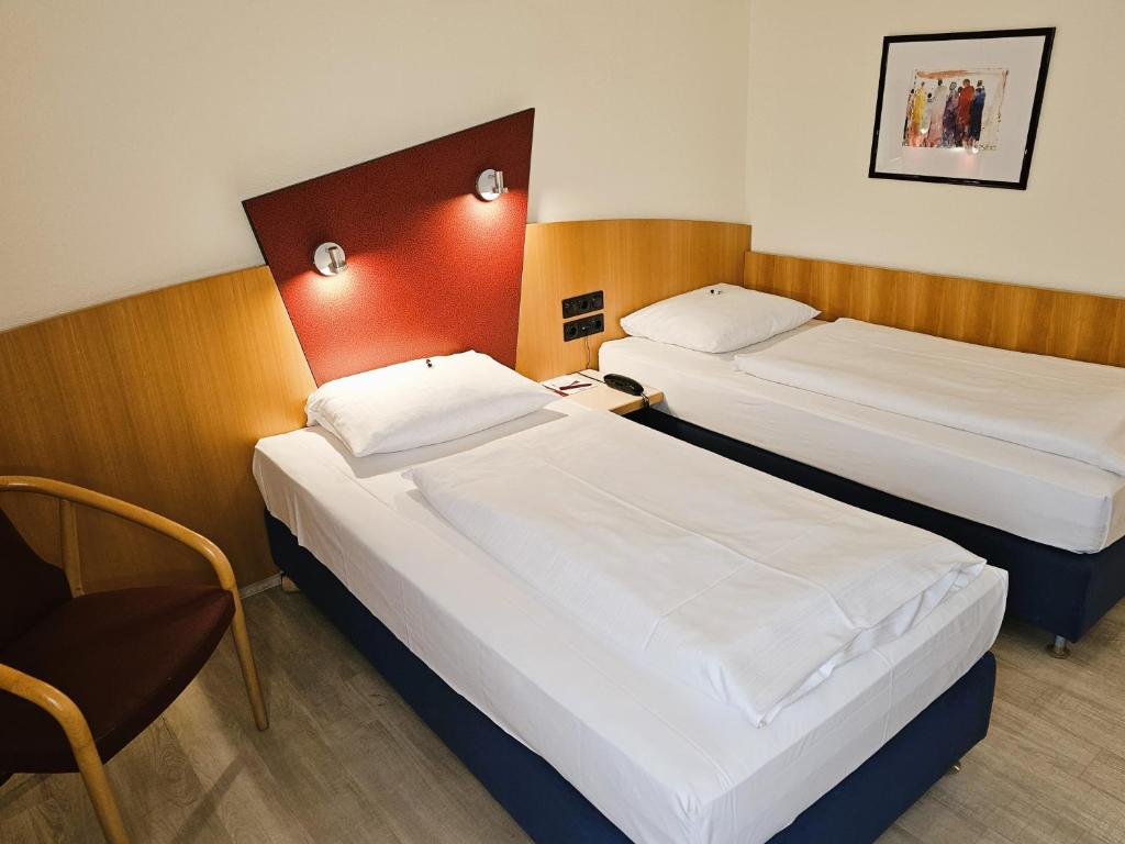 Postel nebo postele na pokoji v ubytování Arvena Park Hotel