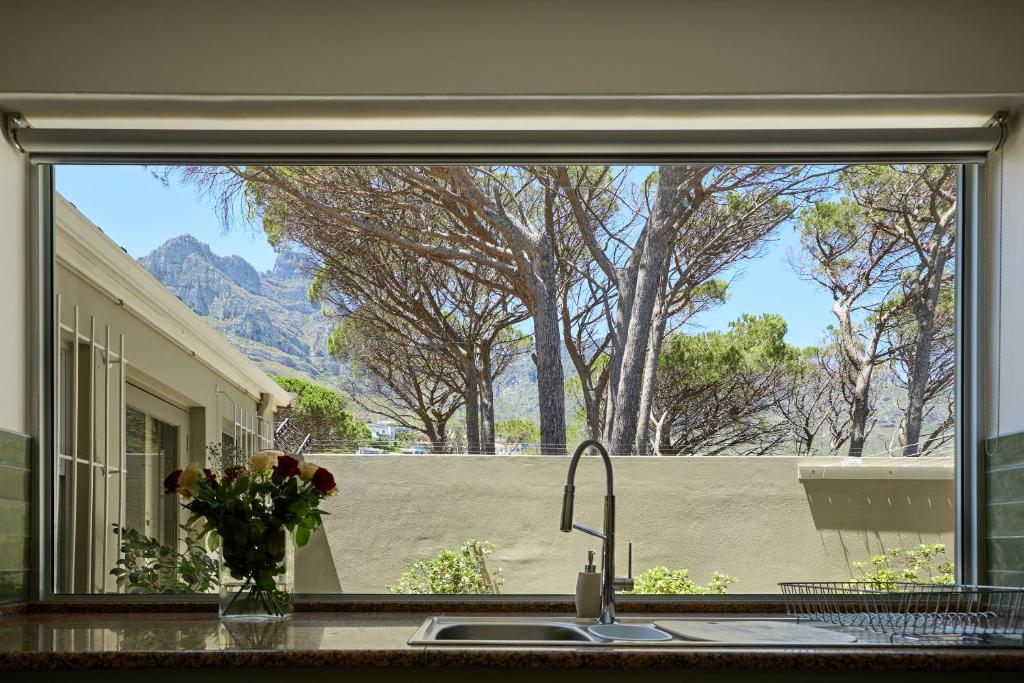 a kitchen window with a view of a mountain at 42 On Strathmore in Cape Town
