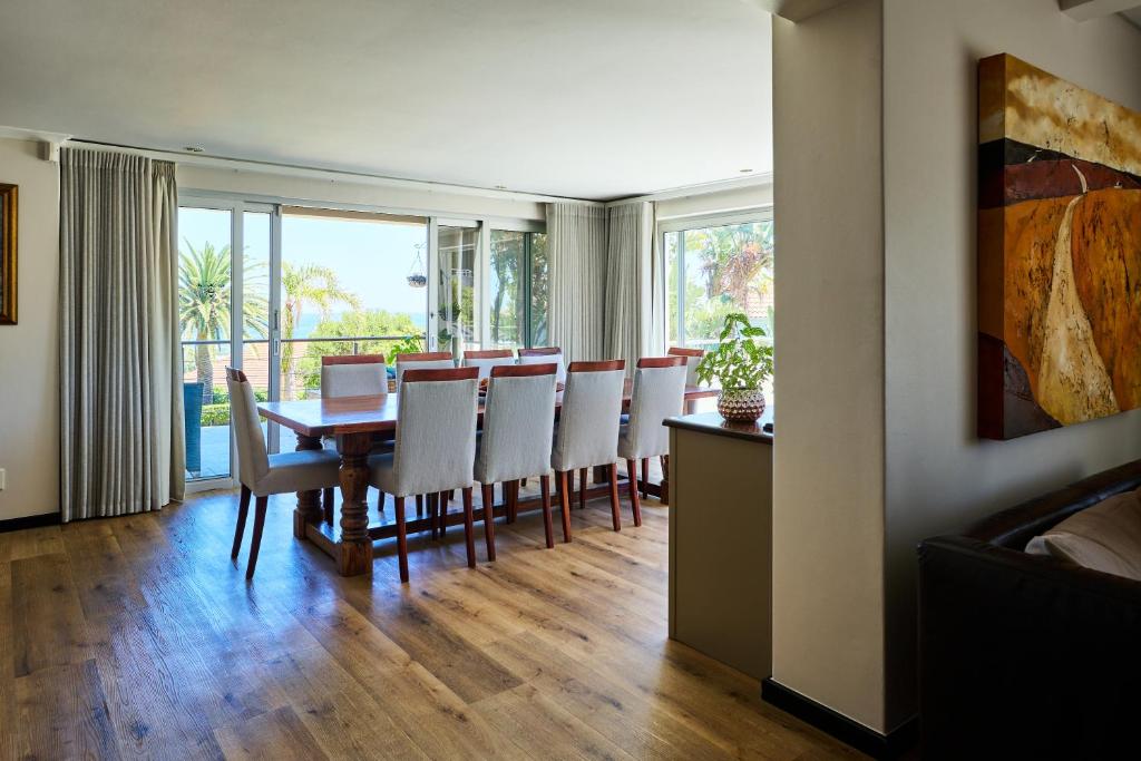 a dining room with a table and chairs at 42 On Strathmore in Cape Town