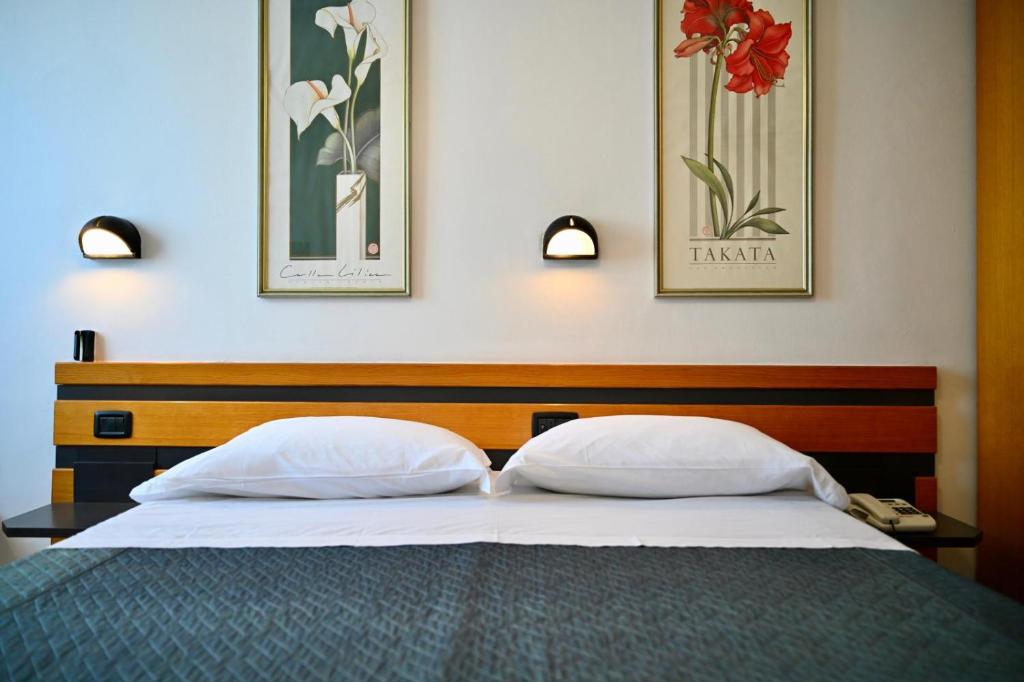 Postel nebo postele na pokoji v ubytování Hotel Roma Assisi