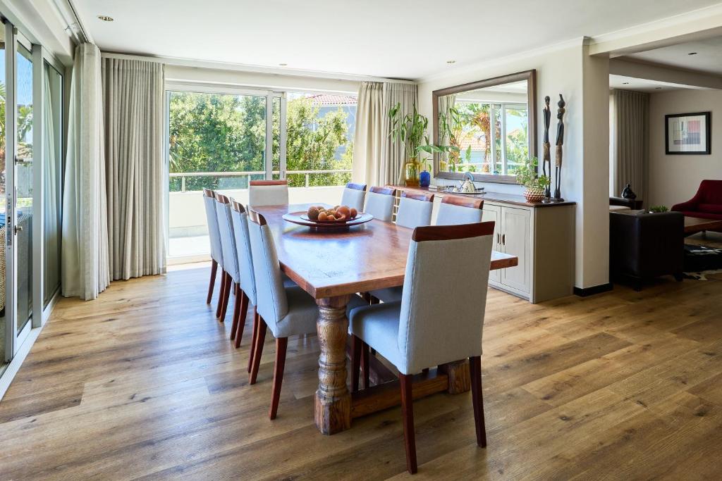 a dining room with a wooden table and chairs at 42 On Strathmore in Cape Town