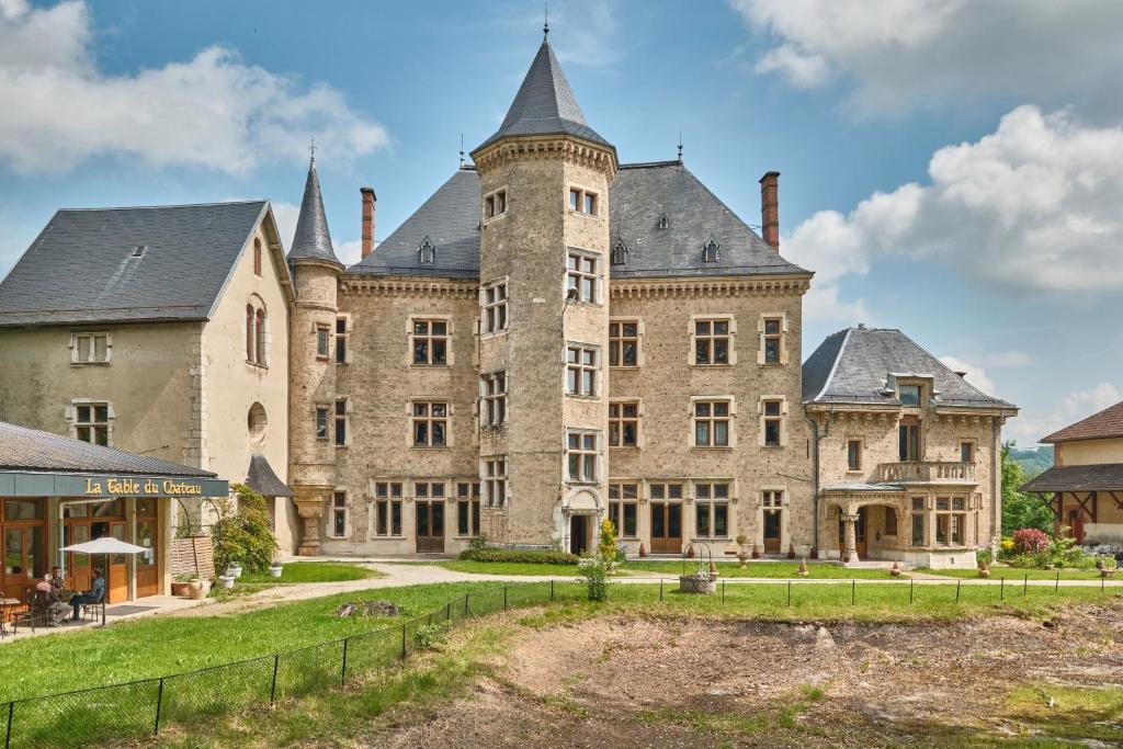 a large stone castle with turrets at Suite Marguerite chez l'habitant in Saint-Geoire-en-Valdaine
