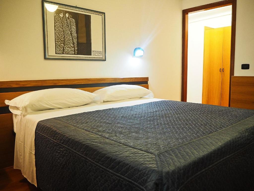 Postel nebo postele na pokoji v ubytování Hotel Roma Assisi