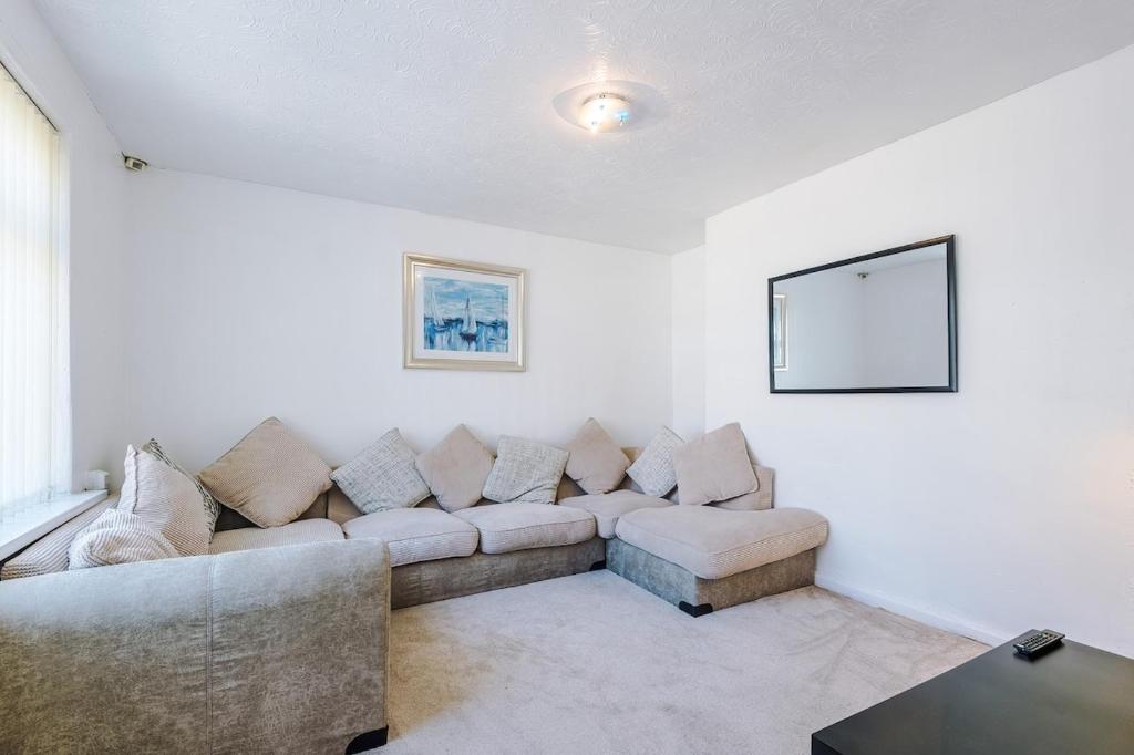 a living room with a couch and a table at Stylish 3 bed house sleeps 5 free parking in Dudley Hill