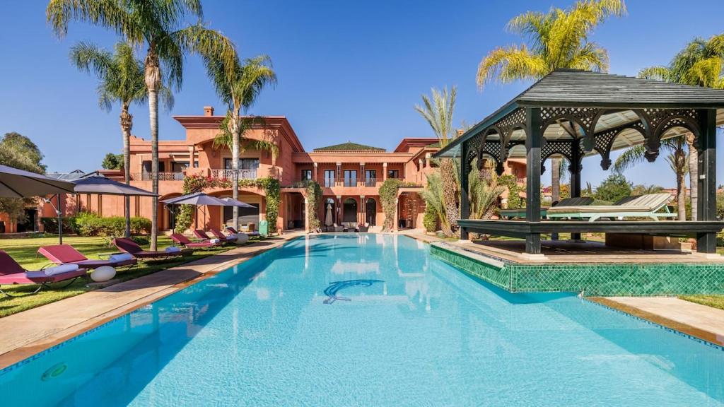 a large swimming pool with a gazebo at Villa Hiba Luxury & Paddle in Najem