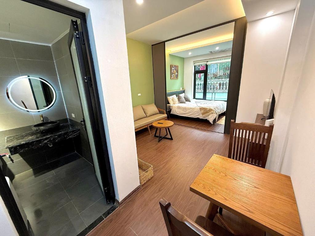 a living room with a table and a mirror at Apartment in Ho Tay in Hanoi