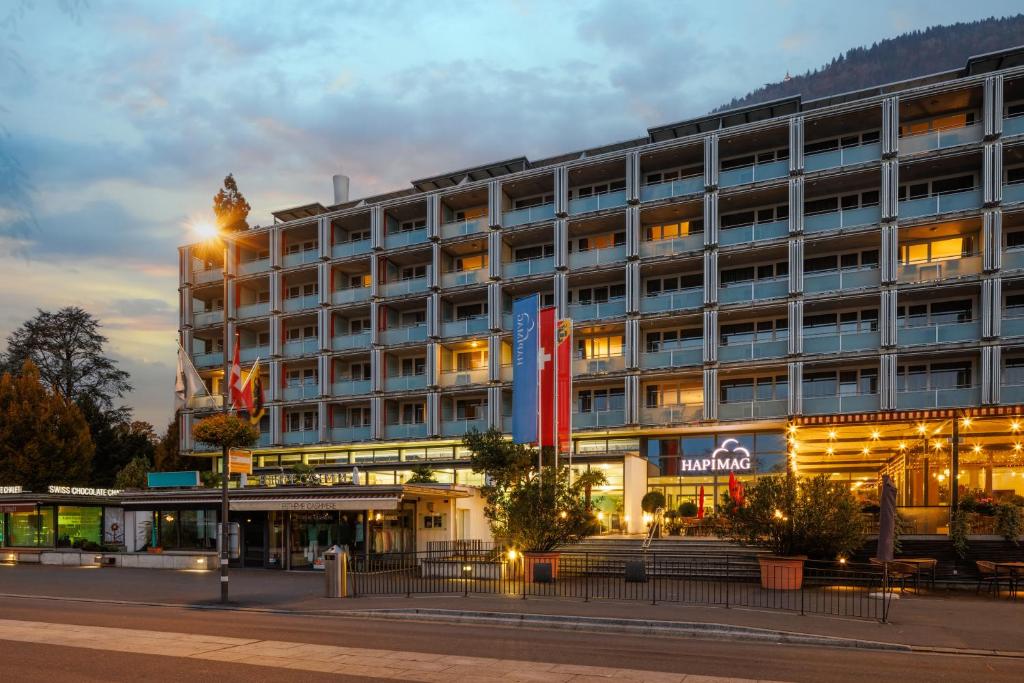 a hotel with a clock tower on top of it at Hapimag Ferienwohnungen Interlaken in Interlaken