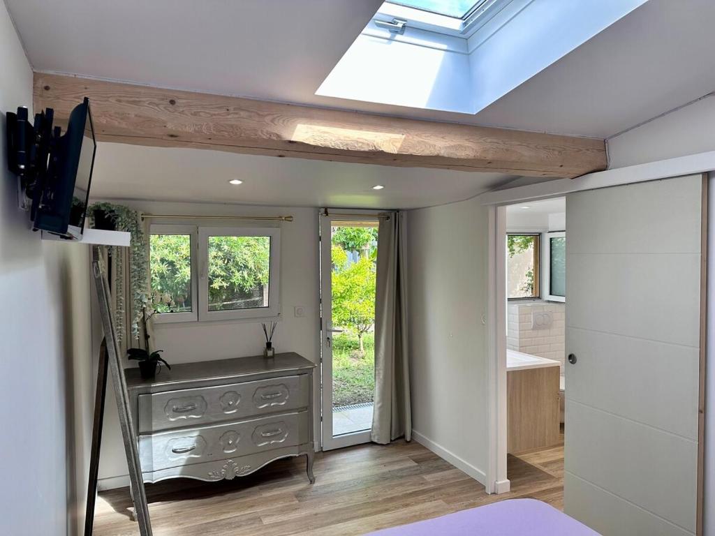 a room with a skylight and a bathroom with a sink at Chambres au calme, free parking in Cagnes-sur-Mer