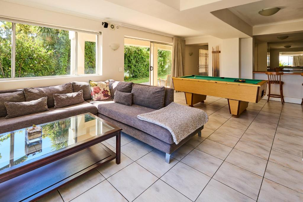 a living room with a couch and a pool table at 42 On Strathmore in Cape Town