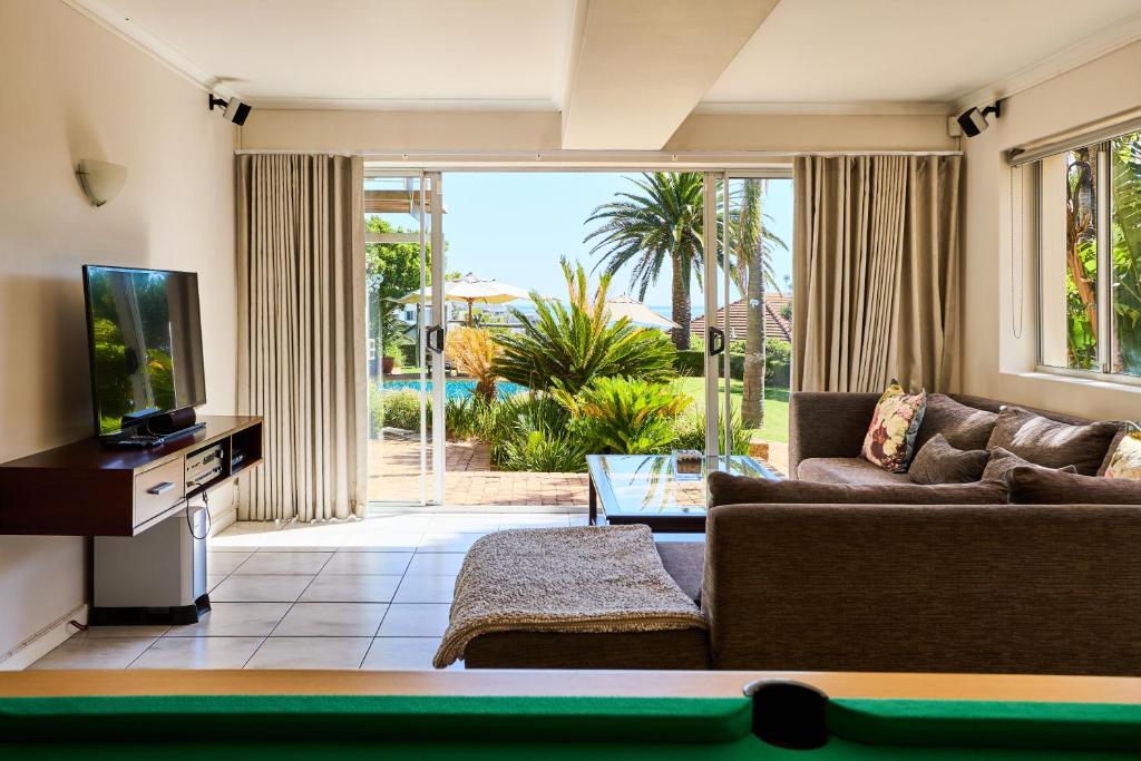 a living room with a couch and a pool table at 42 On Strathmore in Cape Town