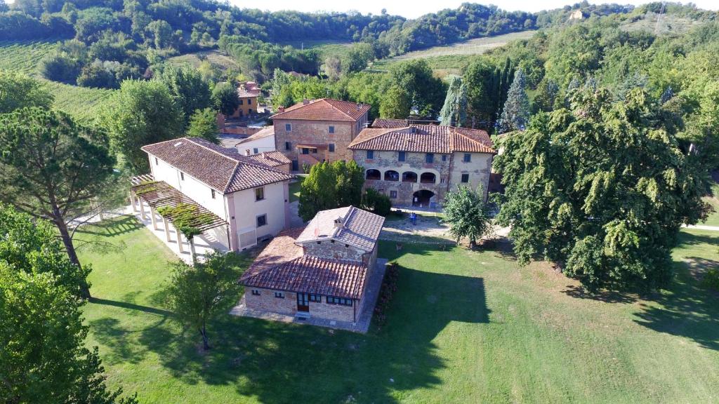 an aerial view of a house in a green field at Antico Borgo La Torre Agriturismo in Reggello