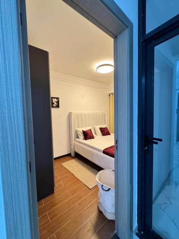 a bedroom with a bed and a room with a mirror at Lovely one bedroom in Kilimani near yaya centre in Nairobi
