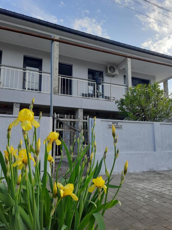 a house with yellow flowers in front of it at Weekender guesthouse 4 in K'obulet'i
