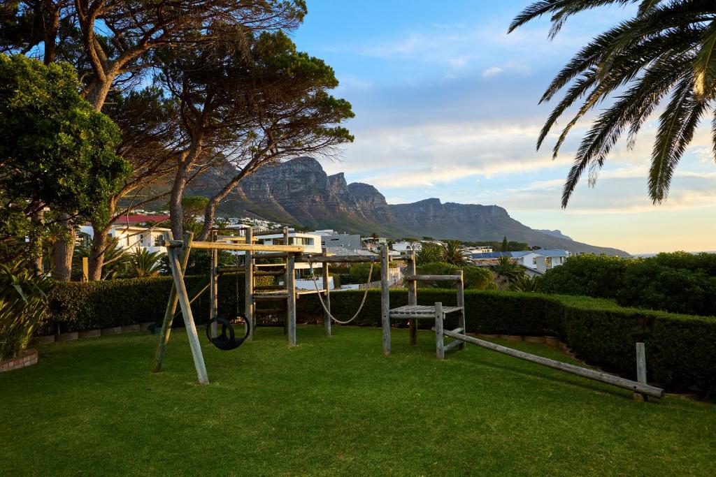a park with a playground with a mountain in the background at 42 On Strathmore in Cape Town