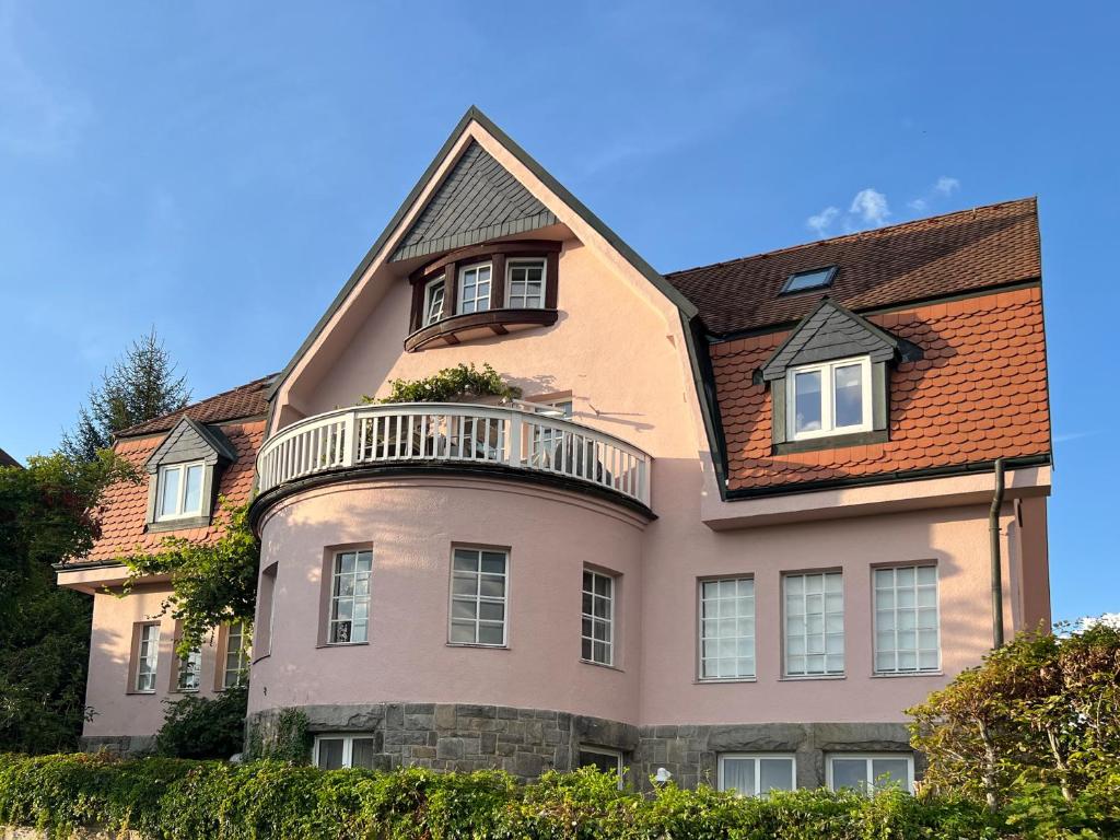 a large house with a balcony on top of it at Rosa Villa Selb in Selb
