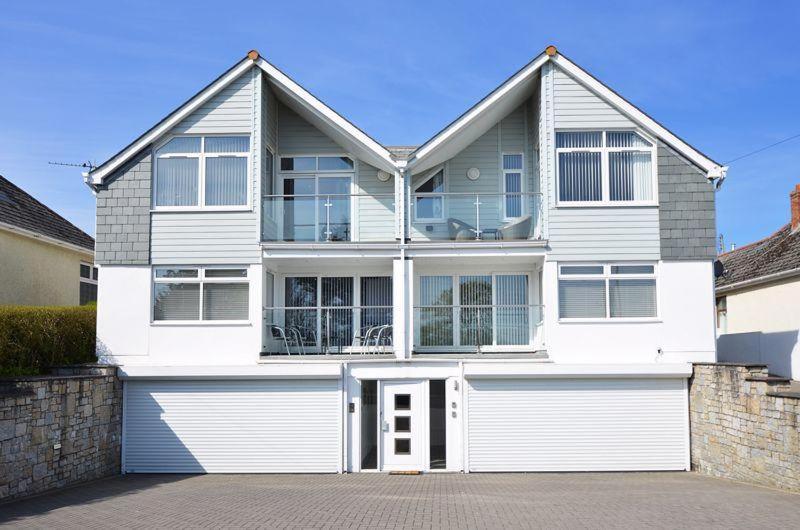 a large white house with a garage at Foxwood in Kenwyn