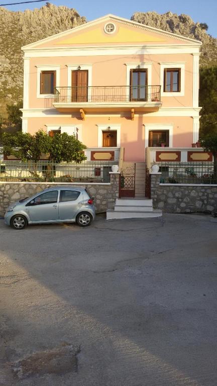 a car parked in front of a house at Pedi Breeze in Symi