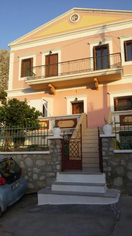 a large house with stairs in front of it at Pedi Breeze in Symi