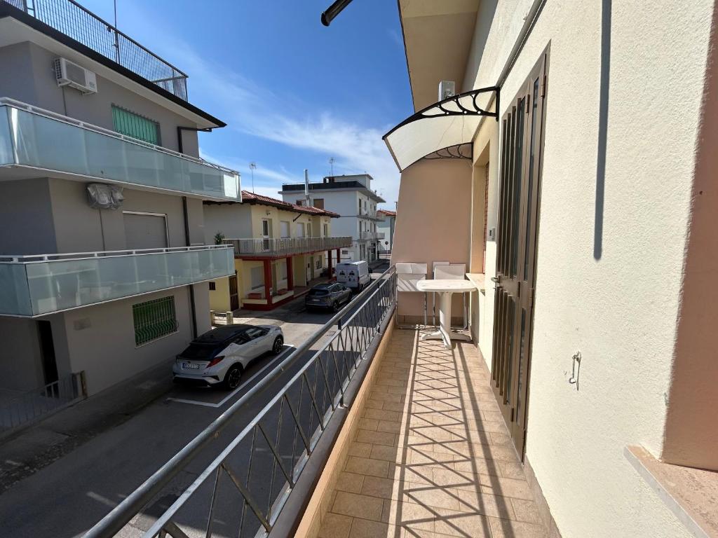 a balcony with a car parked on the side of a building at Anthea- Paluzza Apartment & Parking in Lignano Sabbiadoro