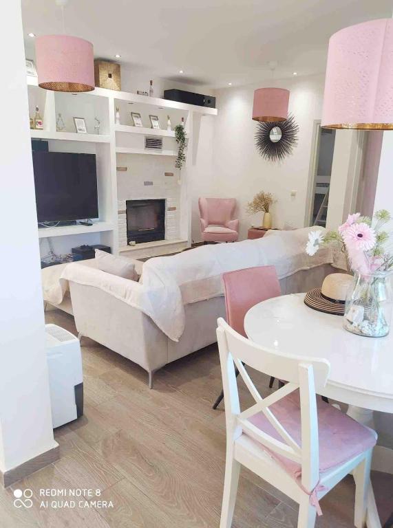a living room with a couch and a table at Luxury mini villas AA in Kríni