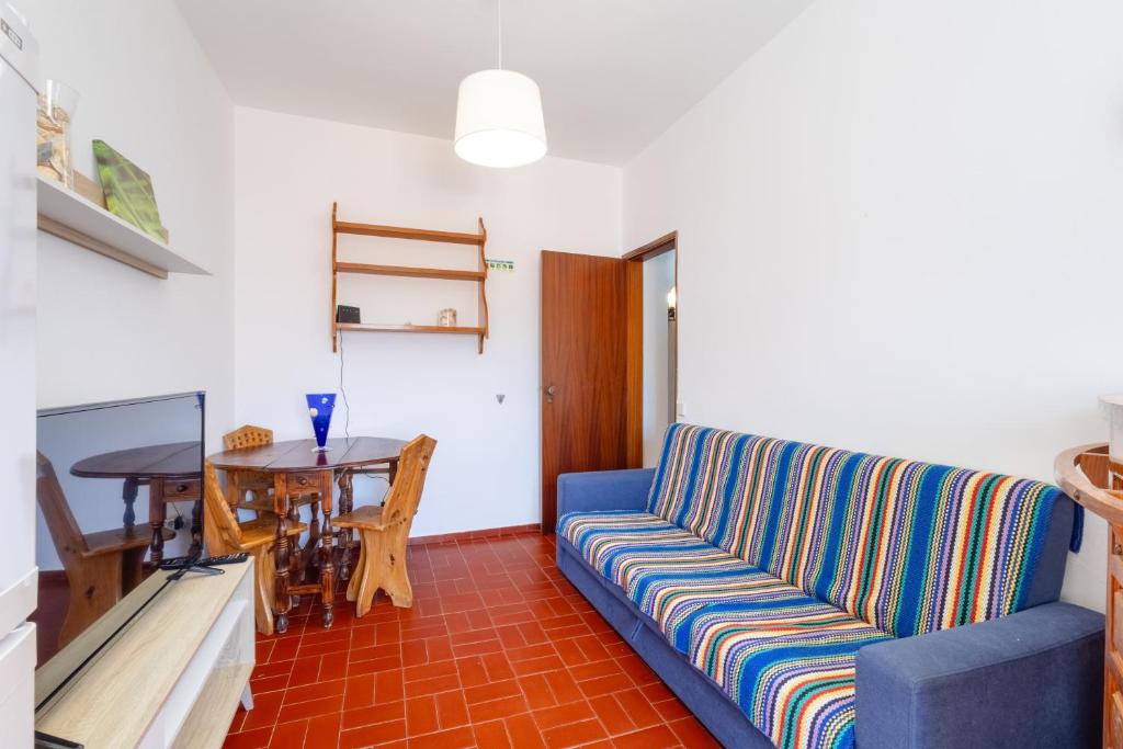 a living room with a blue couch and a table at Seaview-4-You in Lagos