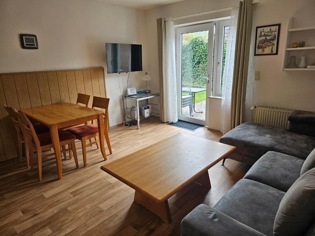a living room with a table and a couch at Ferienwohnung Seegat Nr 4 in Norden