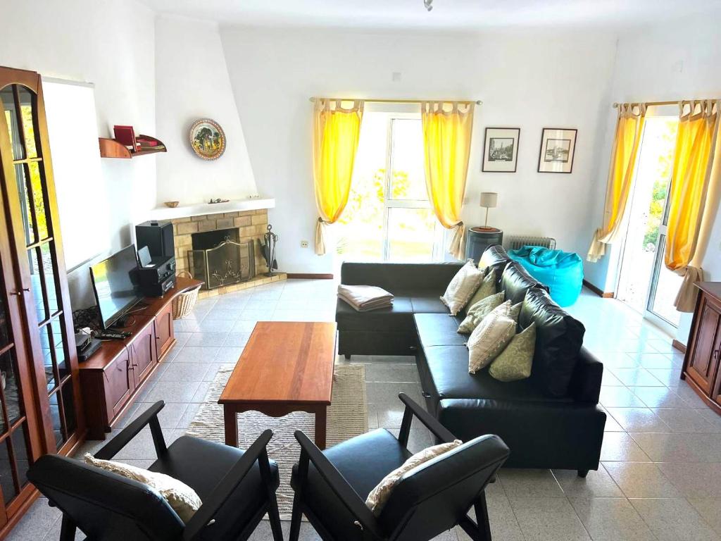 a living room with a couch and a table at Casa Flora - Vale da Telha - Nature - Surf & Sun in Aljezur