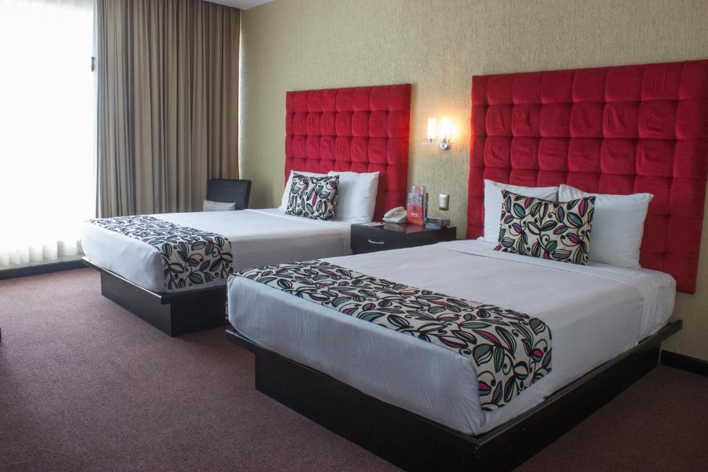 A bed or beds in a room at Hotel Vista Inn Premium