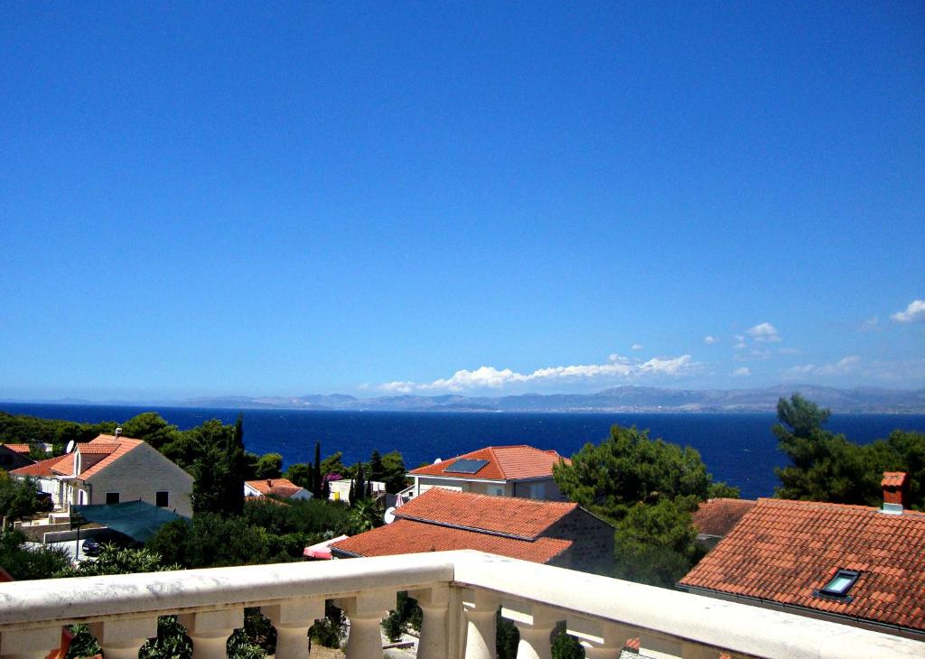 a view of the ocean from the balcony of a house at Apartments Paula in Splitska