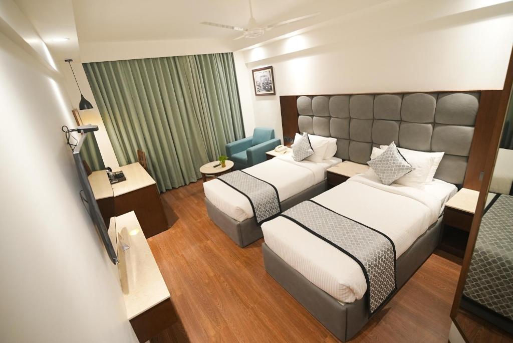 Postel nebo postele na pokoji v ubytování Ramee Guestline Tirupati