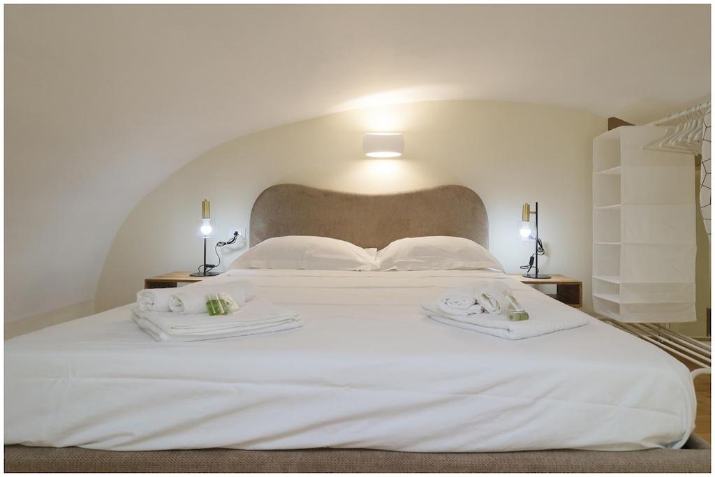 a large white bed with two white towels on it at Piave X Design Loft Quadrilatero WiFi AC in Turin