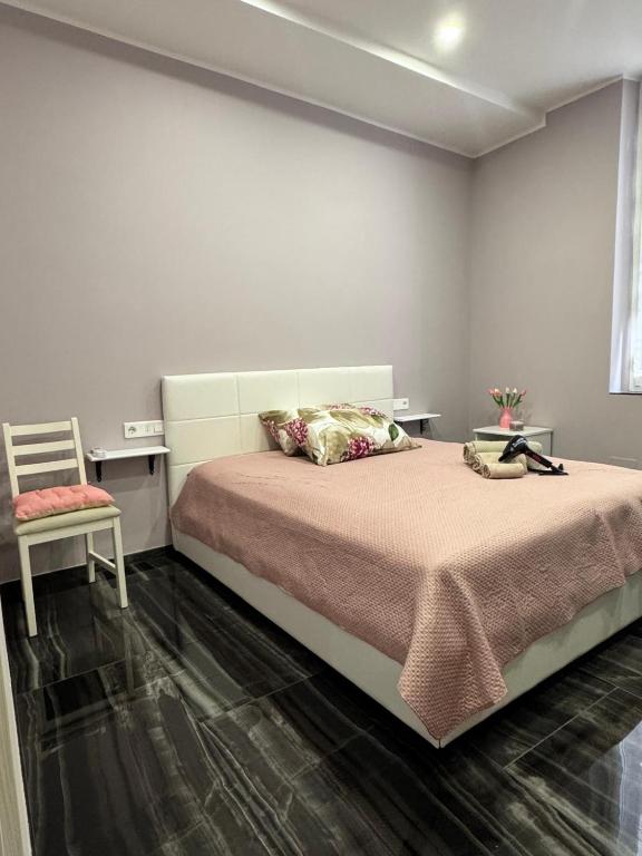 a bedroom with a large bed and a chair at Il tulipano in Ventimiglia