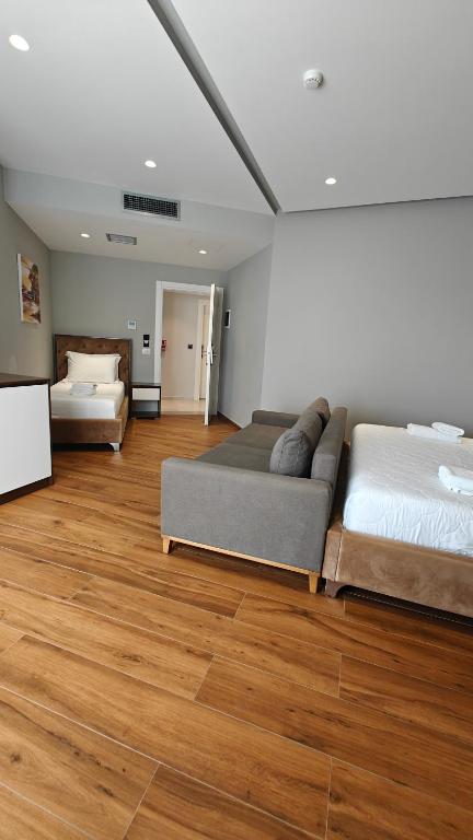 a living room with two beds and a couch at King Hotel Ksamil in Ksamil