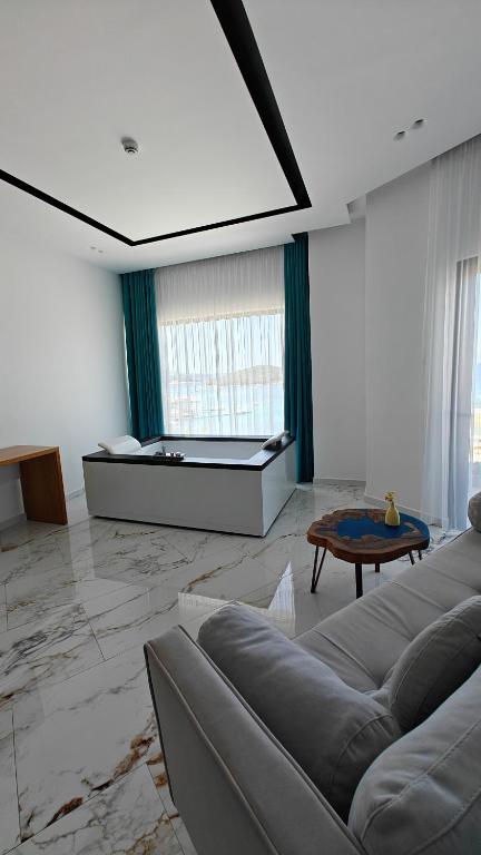 a living room with a couch and a bed at King Hotel Ksamil in Ksamil