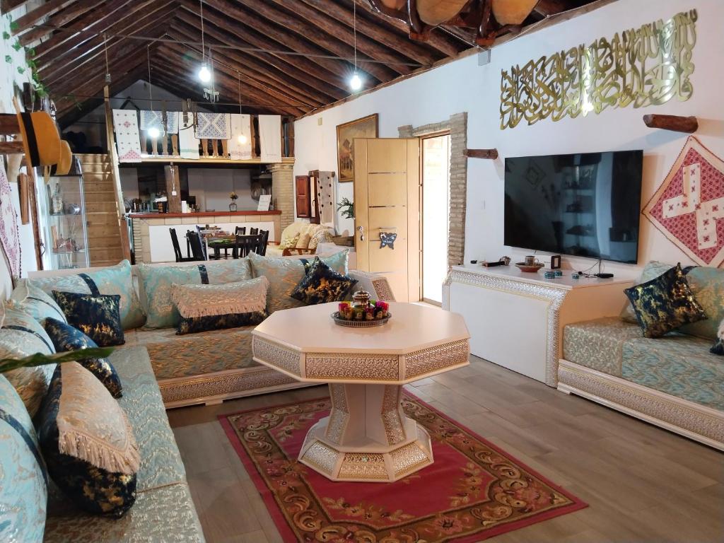 a living room with a couch and a table at Casa rural Cerro Campón in Carmona