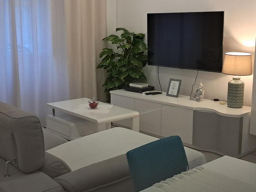 a living room with a tv on a wall at My home in Cercal