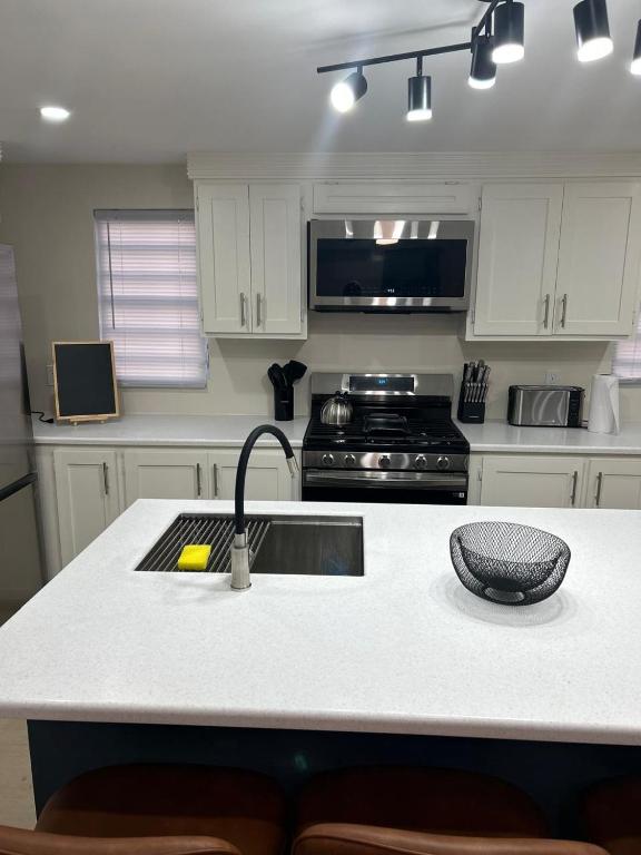 a kitchen with a sink and a stove at Xoop Homes - Ixora #1 in Saint Johnʼs