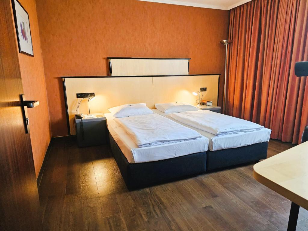 Postel nebo postele na pokoji v ubytování Arvena Park Hotel