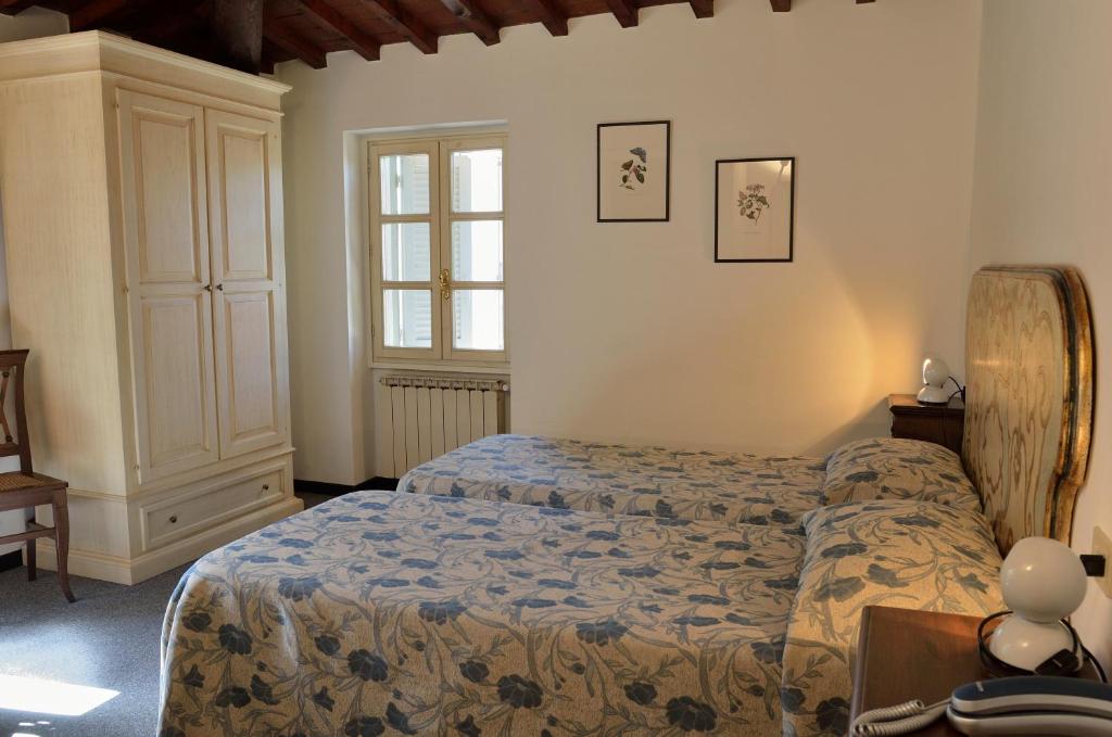 Postel nebo postele na pokoji v ubytování Hotel Calzaiolo