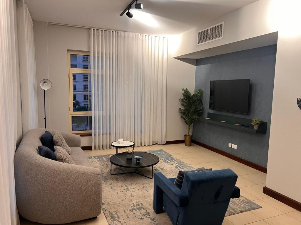 Una sala de estar con un sofá y un televisor. en 217 KING ABDULLAH ECONOMIC CiTY Family and business, en King Abdullah Economic City