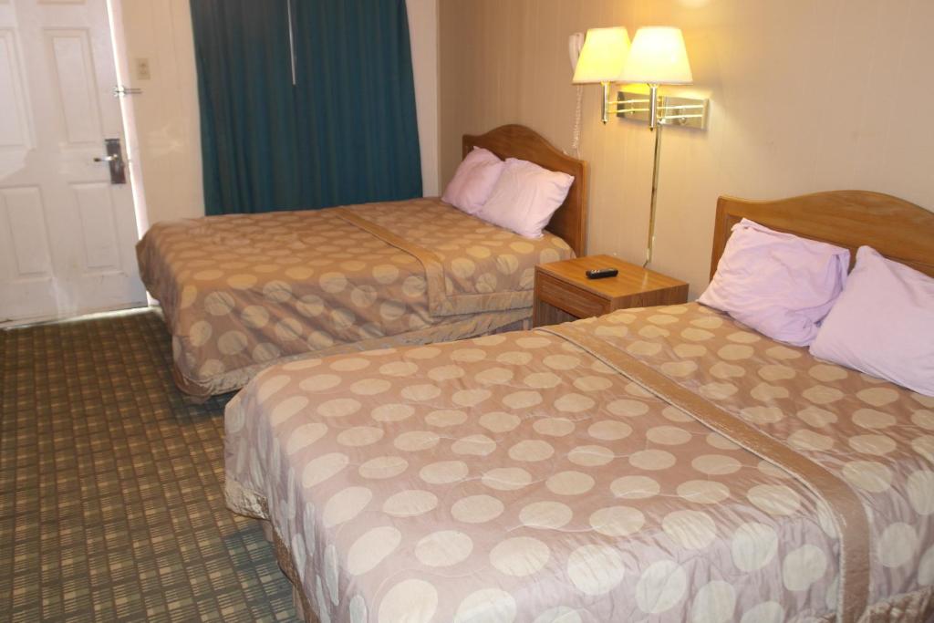 a hotel room with two beds in a room at Interstate Motel in Wills Point