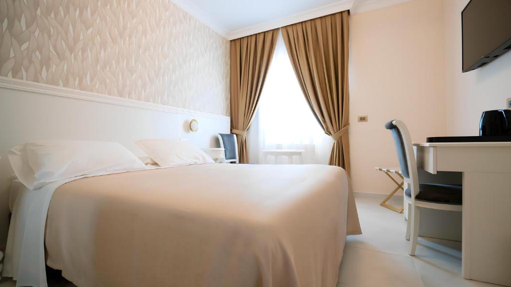 Postel nebo postele na pokoji v ubytování Hotel Sicilia