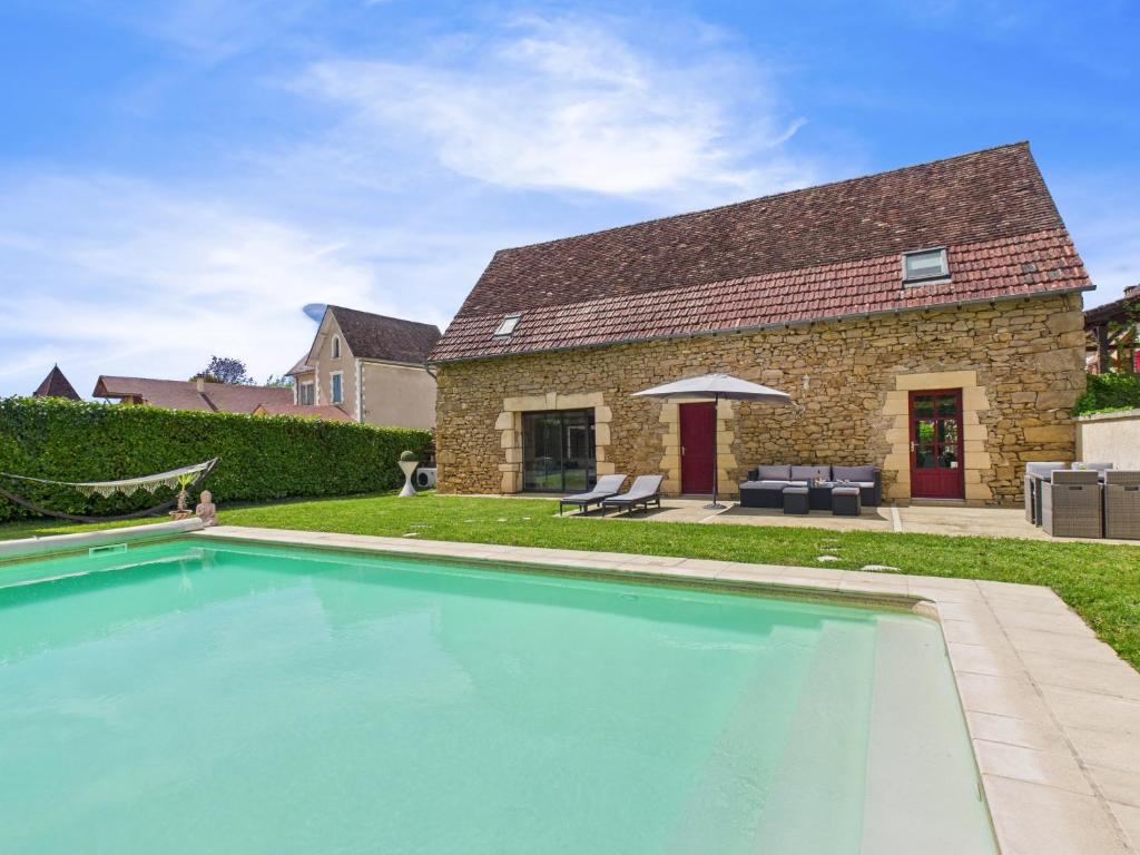 a swimming pool in front of a house at Belle maison pour 6 - Piscine - Dordogne in Saint-Julien-de-Lampon