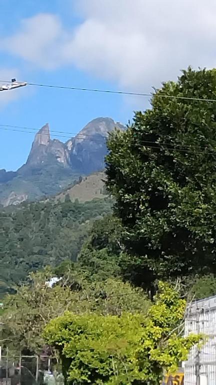 a mountain in the distance with trees in the foreground at Spectacular Agriões Location in Teresópolis