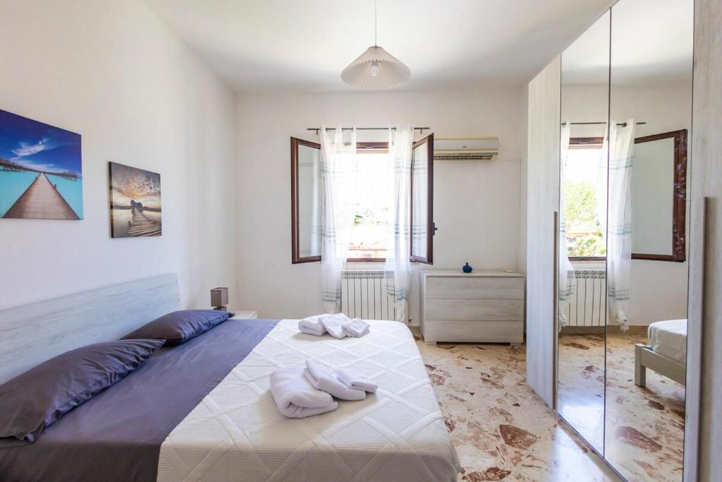 a bedroom with a large bed with towels on it at Casa Cloe Mondello in Palermo